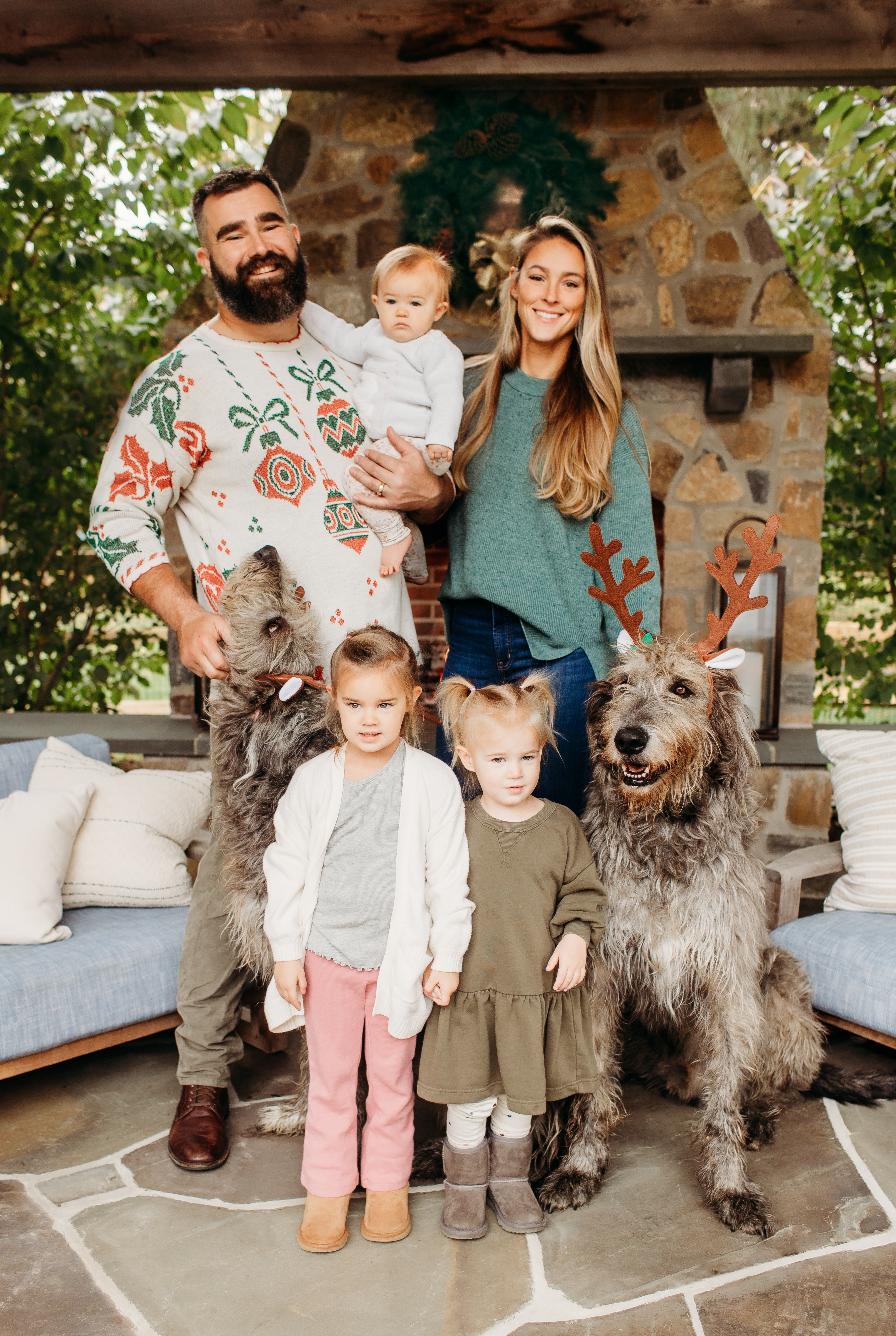 Jason, Kylie, Wyatt [4], Elliotte [2], and Bennett [8 months] Kelce with dogs Winnie and Baloo during their 2023 holiday family photoshoot with design marketplace Minted.