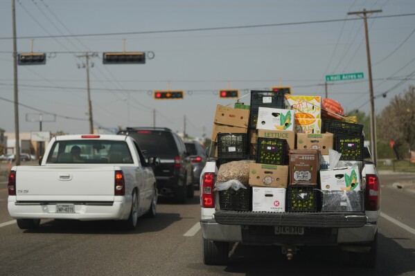 A truck loaded with produce from Mexico and Canada passes through Pharr, Texas, Tuesday, March 4, 2025. (AP Photo/Eric Gay)