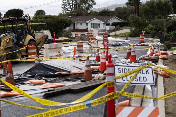 Caution tape closes off streets due to land movement intensified by recent atmospheric rivers in Rancho Palos Verdes, Calif., Feb. 20, 2024. (AP Photo/Jae C. Hong, File)