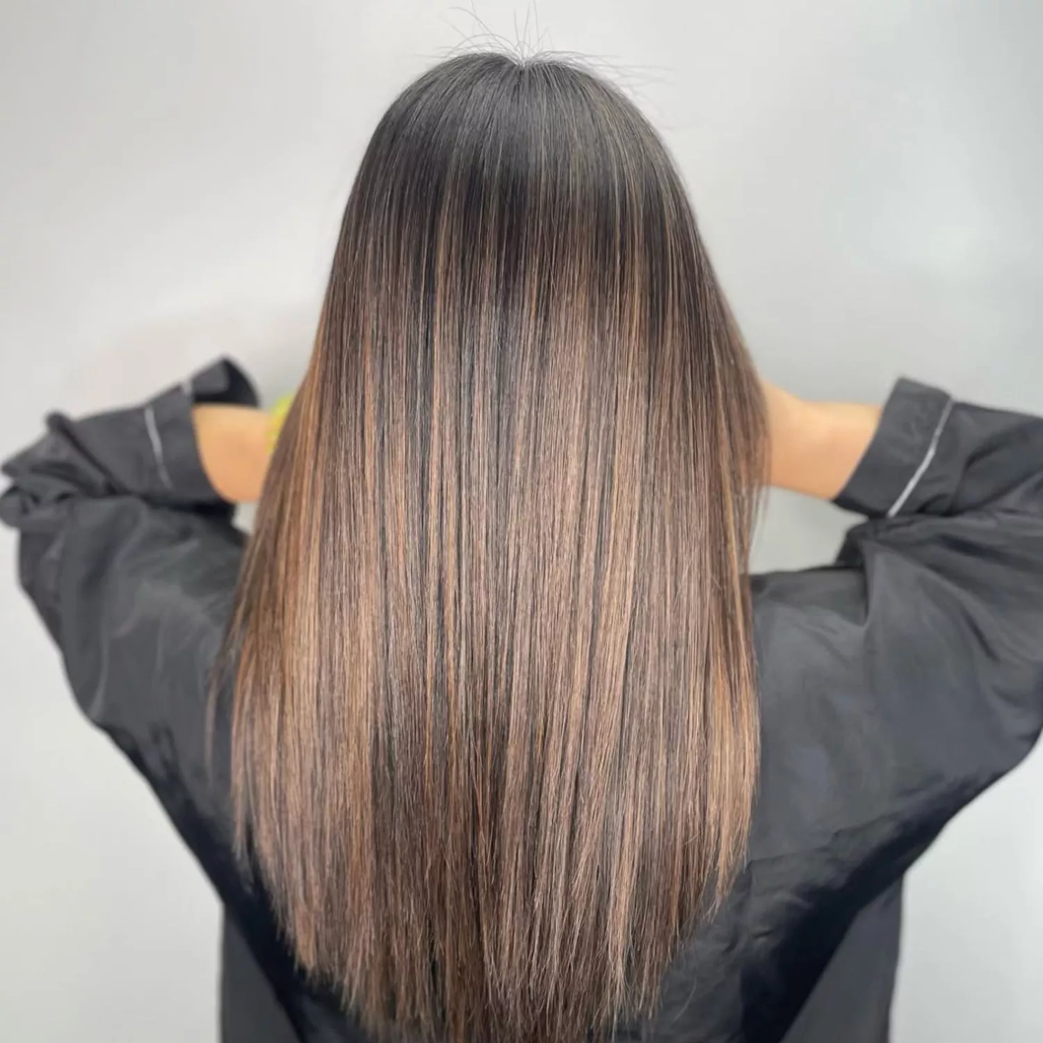 Woman with Brown hair with honey-brown highlights.