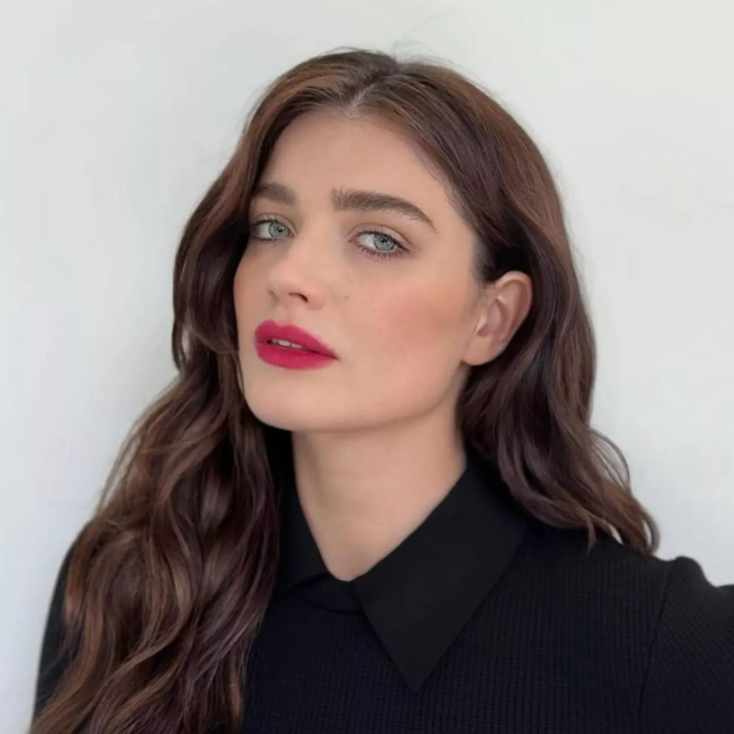 Woman with Brown hair with a hint of warm highlights.