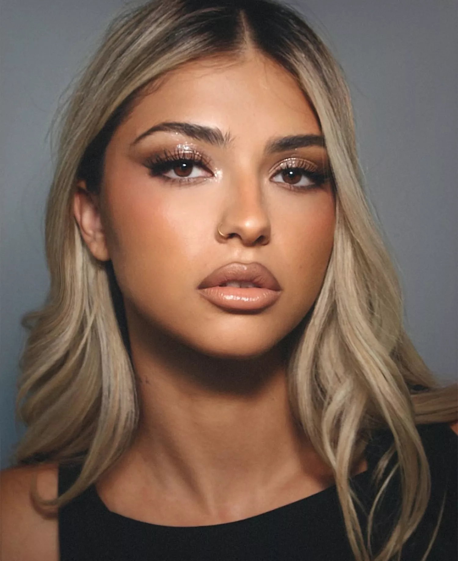 model wears nude glossy makeup look