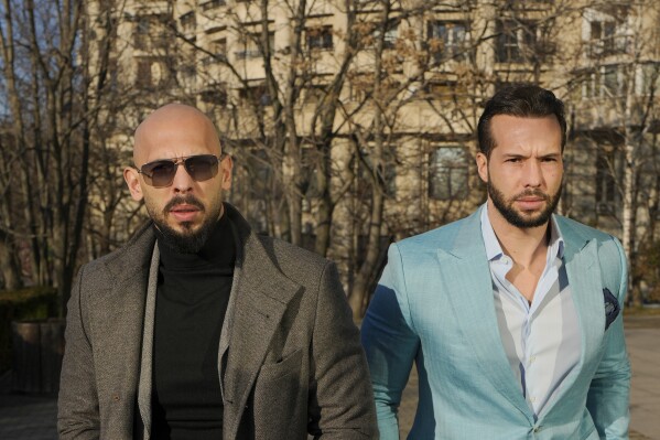 Andrew Tate, left, and his brother Tristan arrive at the Bucharest Tribunal in Bucharest, Romania, Feb. 1, 2024. (AP Photo/Vadim Ghirda, File)
